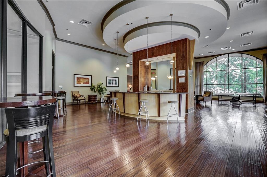 3040 Peachtree Road, Unit 1003 Atlanta, GA 30305 - Photo 34 of 42 a living room with hardwood floor and a table