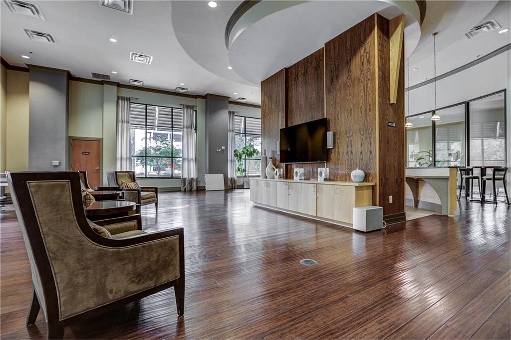3040 Peachtree Road, Unit 1003 Atlanta, GA 30305 - Photo 36 of 42 a living room with furniture wooden floor and a flat screen tv