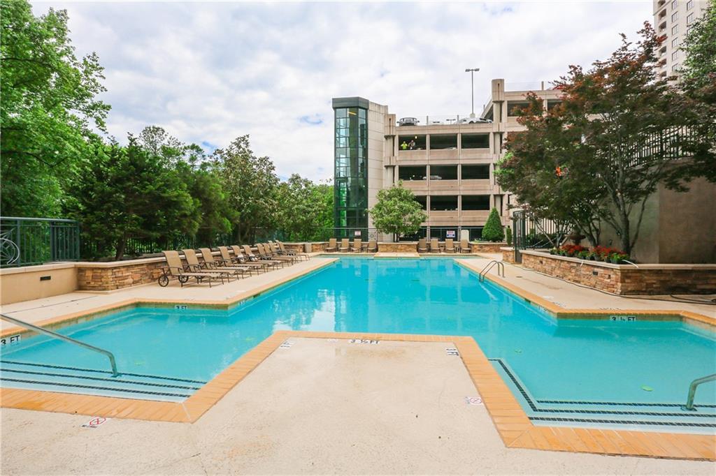 3040 Peachtree Road, Unit 1003 Atlanta, GA 30305 - Photo 38 of 42 a view of a swimming pool with a yard and sitting area