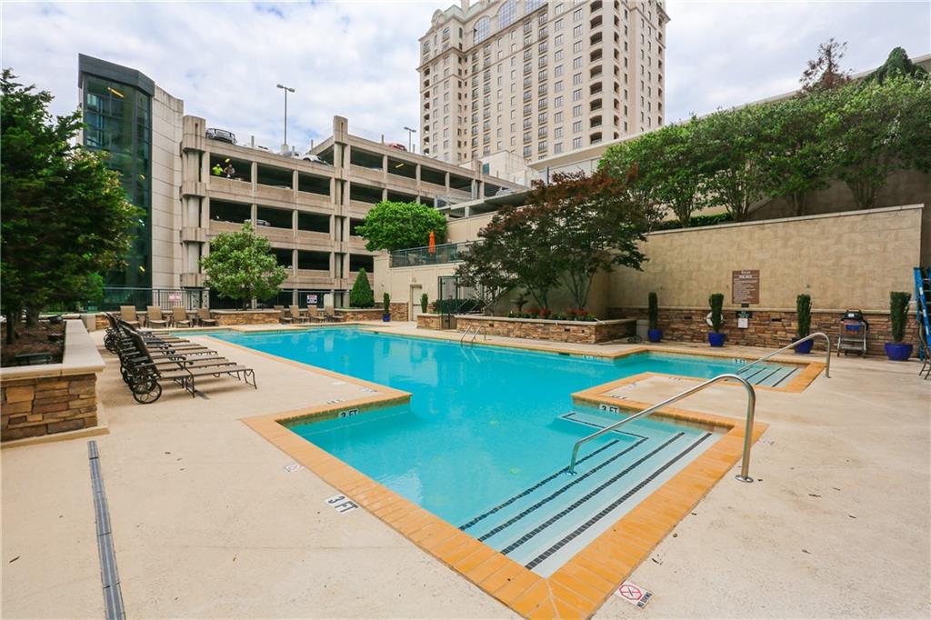 3040 Peachtree Road, Unit 1003 Atlanta, GA 30305 - Photo 39 of 42 a view of a swimming pool with a lounge chairs