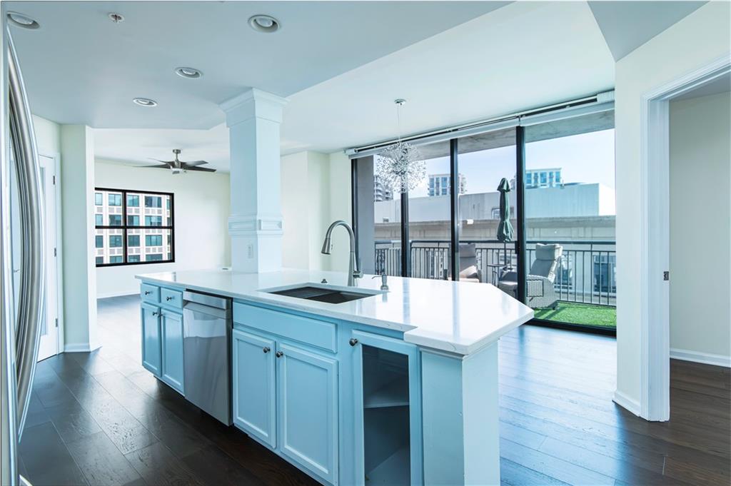 3040 Peachtree Road, Unit 1003 Atlanta, GA 30305 - Photo 6 of 42 a open kitchen with kitchen island a sink and a large window