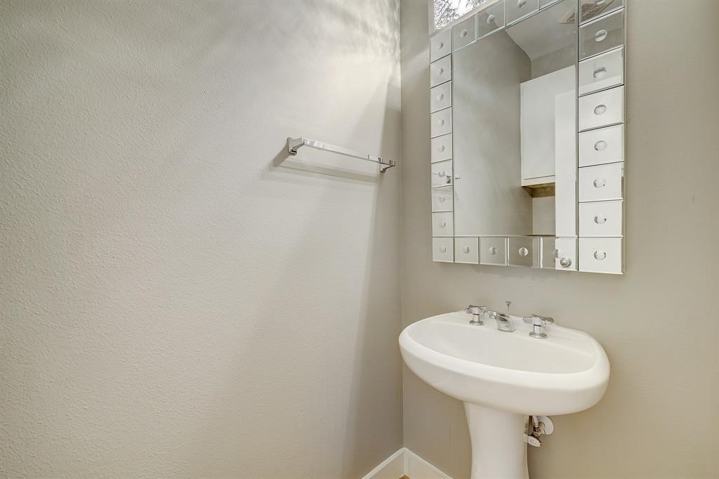 9805 Riddlelink Lane Houston, TX 77025 - Photo 11 of 12 a bathroom with a sink a mirror and a shower