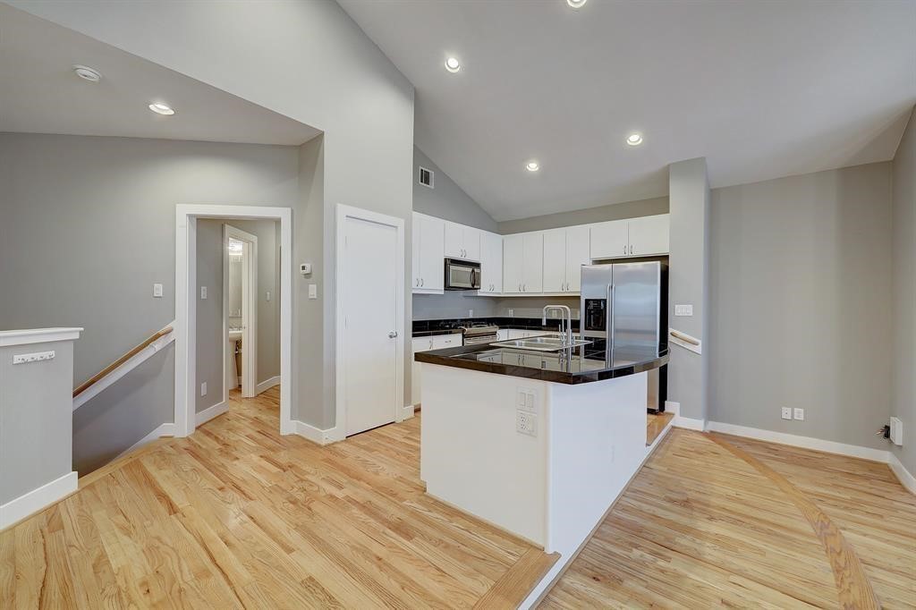 9805 Riddlelink Lane Houston, TX 77025 - Photo 3 of 12 a kitchen with stainless steel appliances granite countertop a refrigerator and a stove top oven