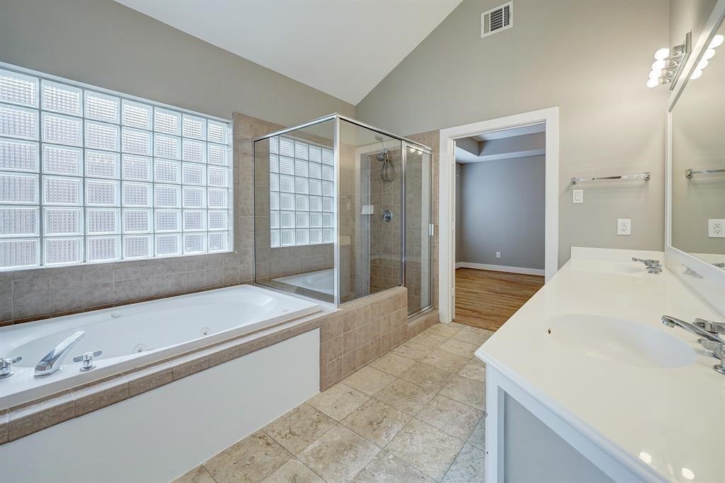 9805 Riddlelink Lane Houston, TX 77025 - Photo 4 of 12 a spacious bathroom with a tub and a sink