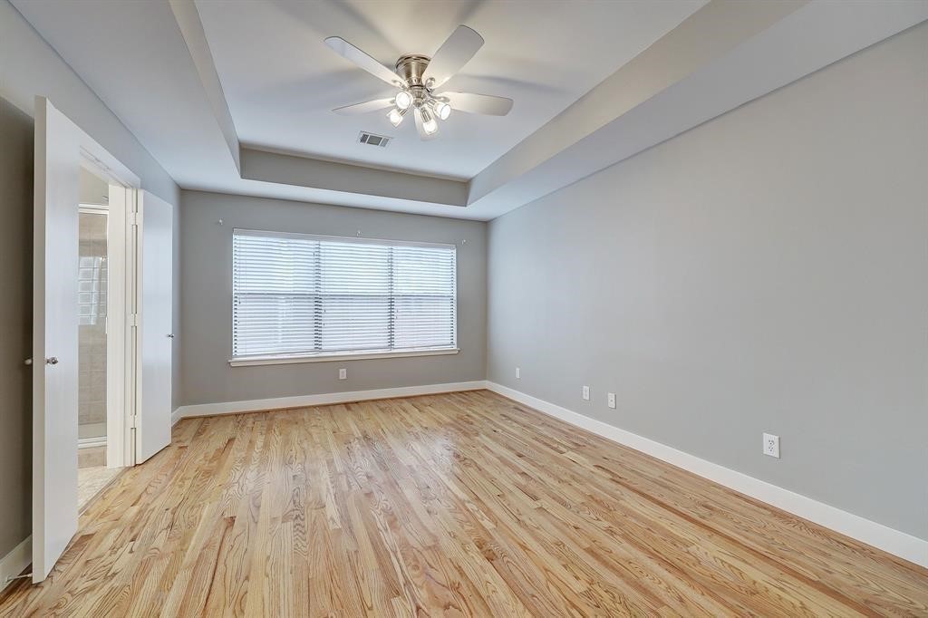 9805 Riddlelink Lane Houston, TX 77025 - Photo 7 of 12 wooden floor in an empty room with a window