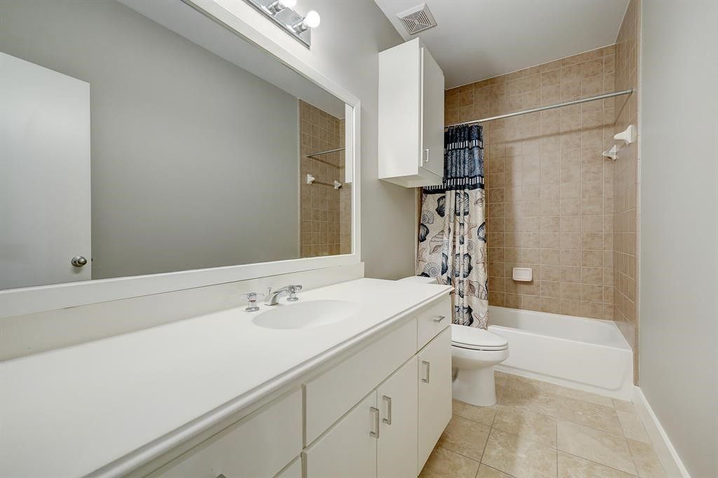 9805 Riddlelink Lane Houston, TX 77025 - Photo 8 of 12 a bathroom with a sink a toilet and shower