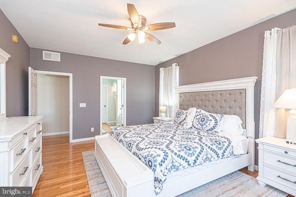 10671 Cathell Road Berlin, MD 21811 - Photo 21 of 63 a bedroom with a large bed and a chandelier