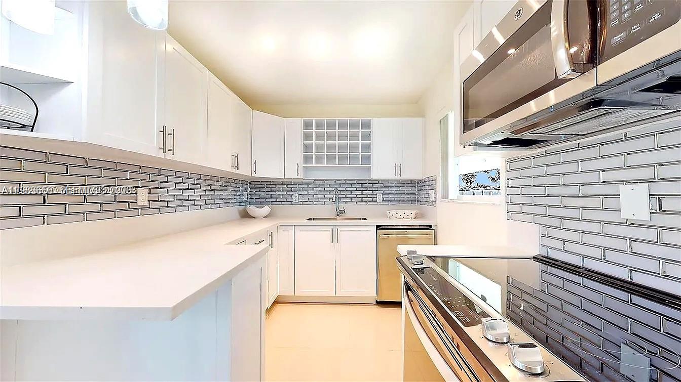 22220 Southwest 112th Avenue Miami, FL 33170 - Photo 5 of 8 a kitchen with a sink stove and cabinets