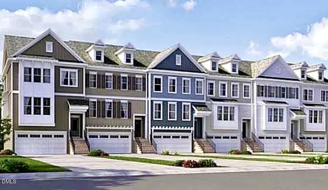 a front view of a residential apartment building with garage and traffic signal