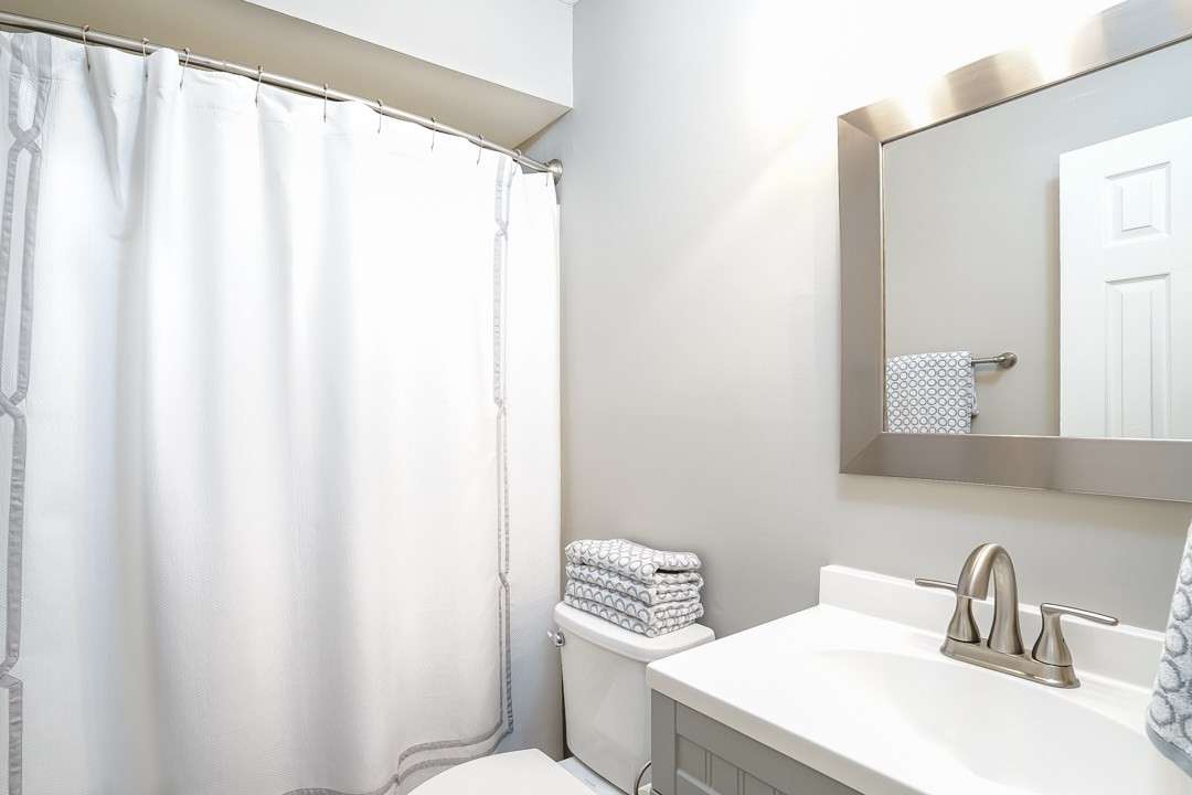 1318 Springlawn Court Raleigh, NC 27609 - Photo 22 of 30 The upstairs hall bath features a new vanity and faucet along with new lighting, mirror, towel bars, toilet and newly tiled floor. Hall Bath