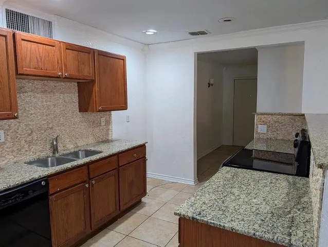 a kitchen with a sink and a stove