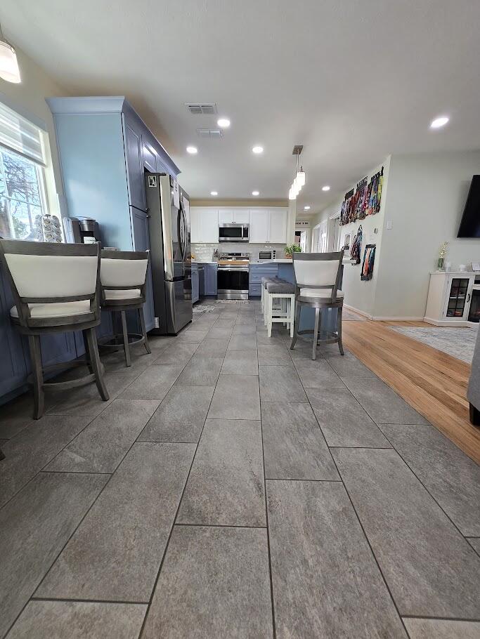 3315 27th Street Lubbock, TX 79410 - Photo 16 of 32 a kitchen with a dining table chairs and view of living room
