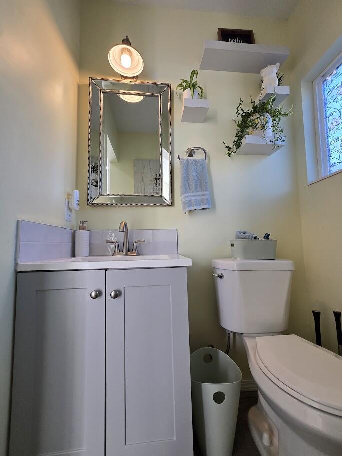 3315 27th Street Lubbock, TX 79410 - Photo 20 of 32 a bathroom with a toilet sink and mirror