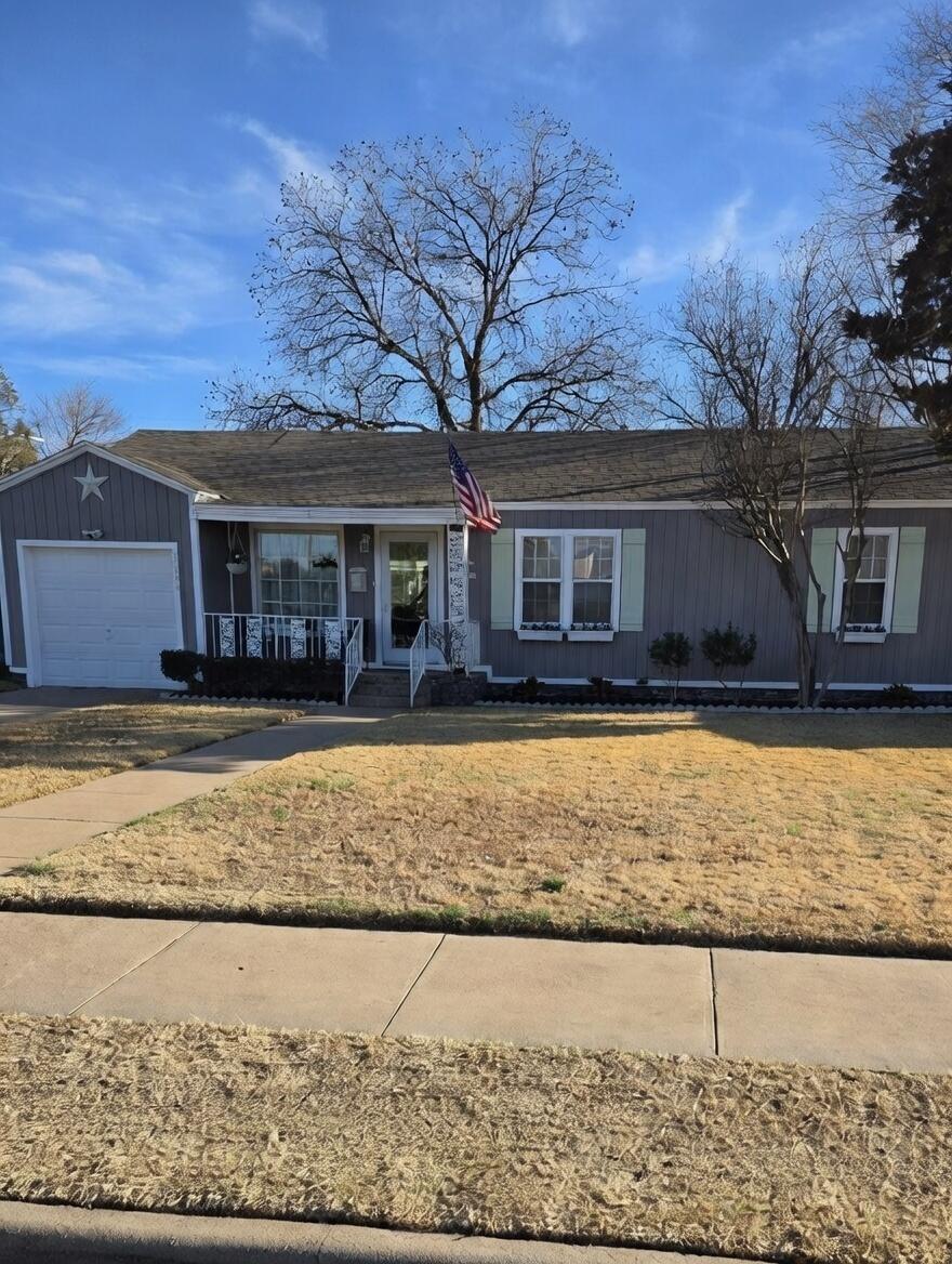 3315 27th Street Lubbock, TX 79410 - Photo 2 of 32 a front view of a house with a yard