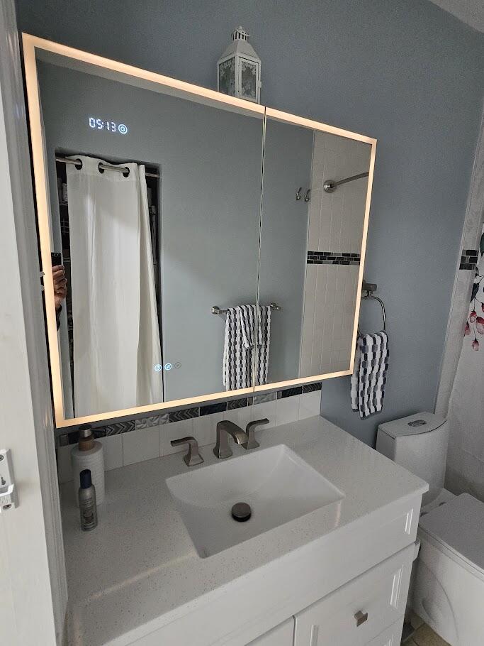 3315 27th Street Lubbock, TX 79410 - Photo 26 of 32 a bathroom with a sink and a mirror