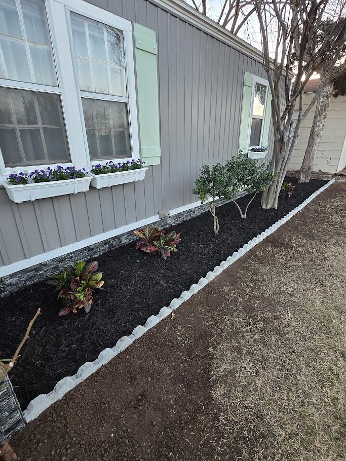 3315 27th Street Lubbock, TX 79410 - Photo 3 of 32 a view of a house with a flower garden