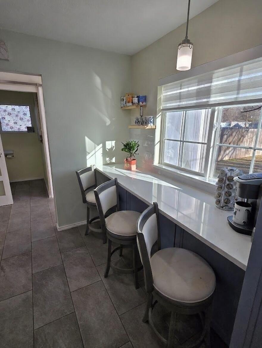 3315 27th Street Lubbock, TX 79410 - Photo 9 of 32 a dining room with furniture and a floor to ceiling window