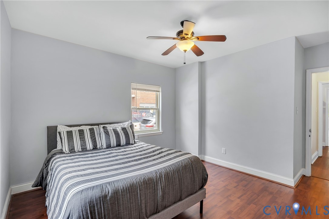 3535 Hanover Avenue, Unit B Richmond, VA 23221 - Photo 7 of 13 a bedroom with a bed and a chandelier
