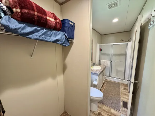 a bathroom with a granite countertop sink toilet and shower