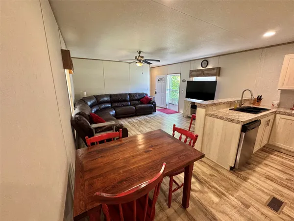 a view of a kitchen with dining table and chairs