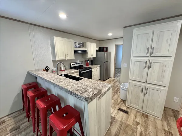 a kitchen with a stove and a sink