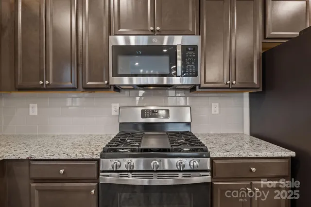 a stove top oven sitting inside of a kitchen