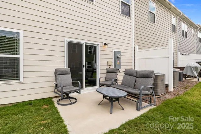 a view of a patio with chairs and a table