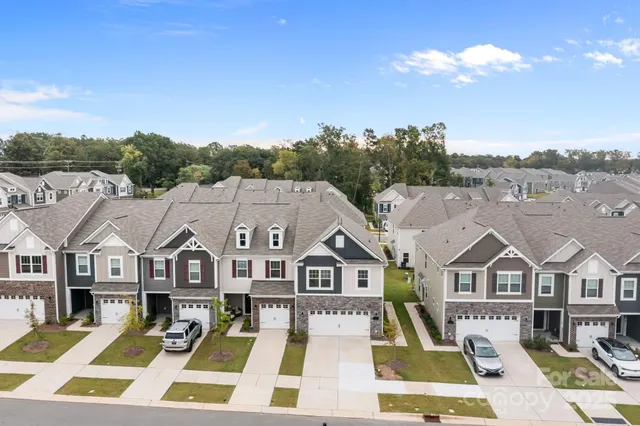 a view of a big yard in front of the houses