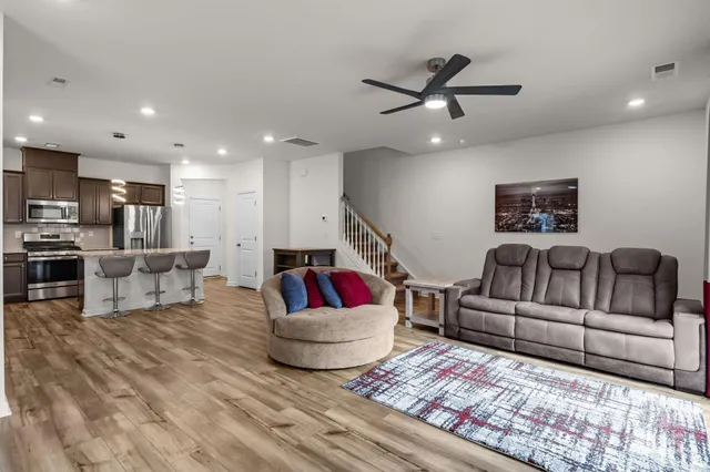 a living room with furniture and kitchen view