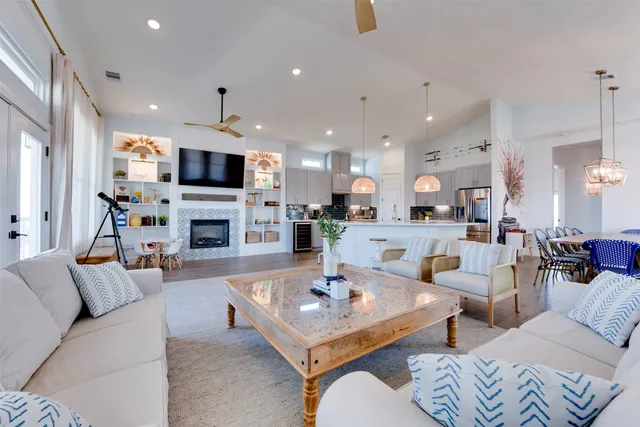 a living room with furniture a fireplace and a flat screen tv