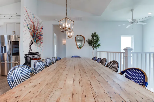 a dining room with furniture a chandelier and wooden floor