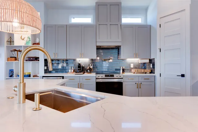 a kitchen with white cabinets and white appliances
