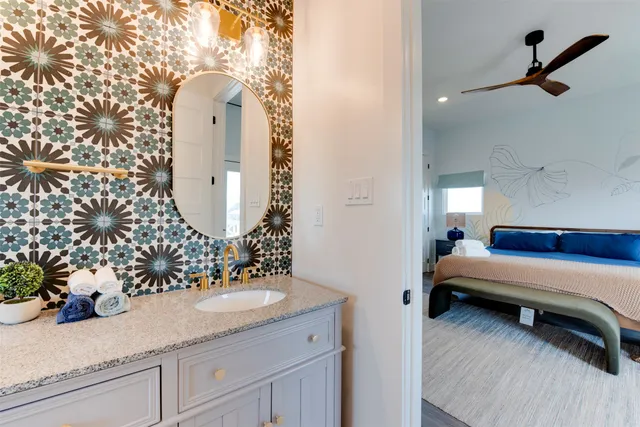 a bathroom with a sink a toilet and a mirror