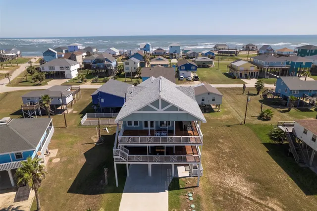 an aerial view of a house with a ocean view