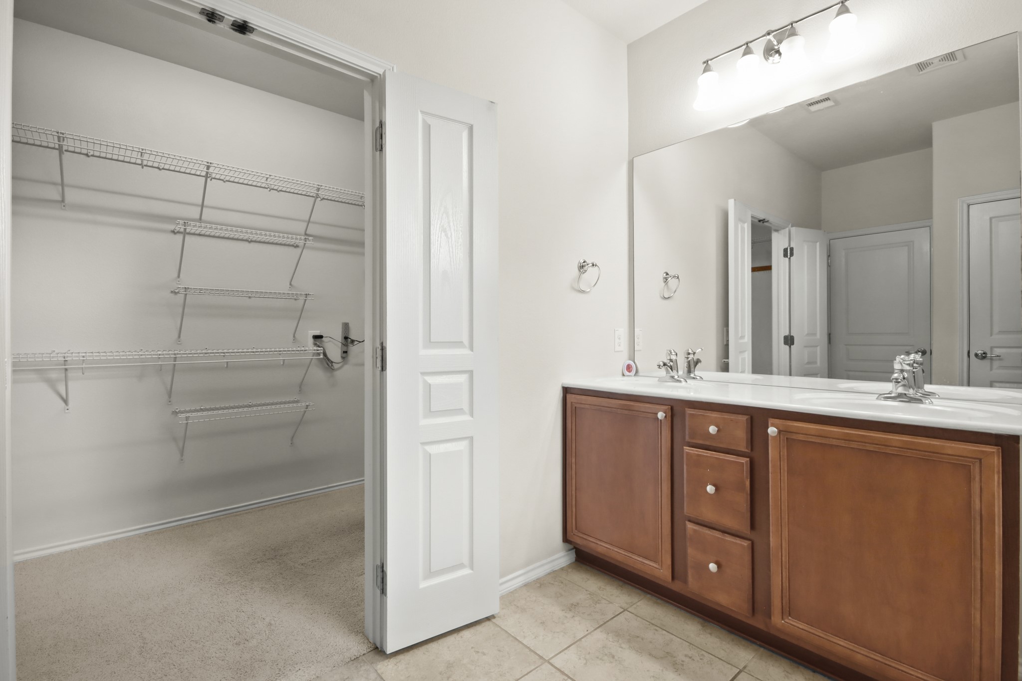 16918 Cherokee Lake Lane Houston, TX 77044 - Photo 12 of 35 a spacious bathroom with a shower sink and mirror