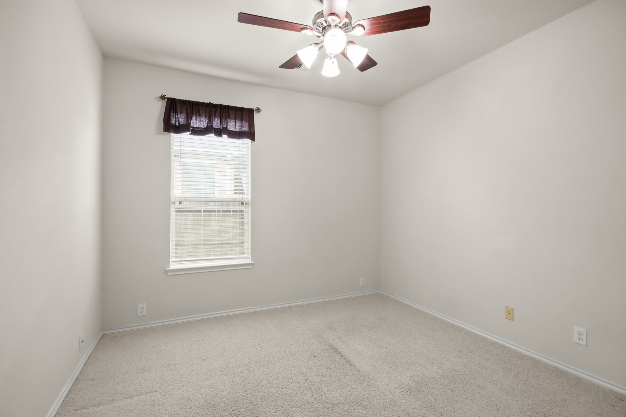 16918 Cherokee Lake Lane Houston, TX 77044 - Photo 17 of 35 an empty room with a window and a fan