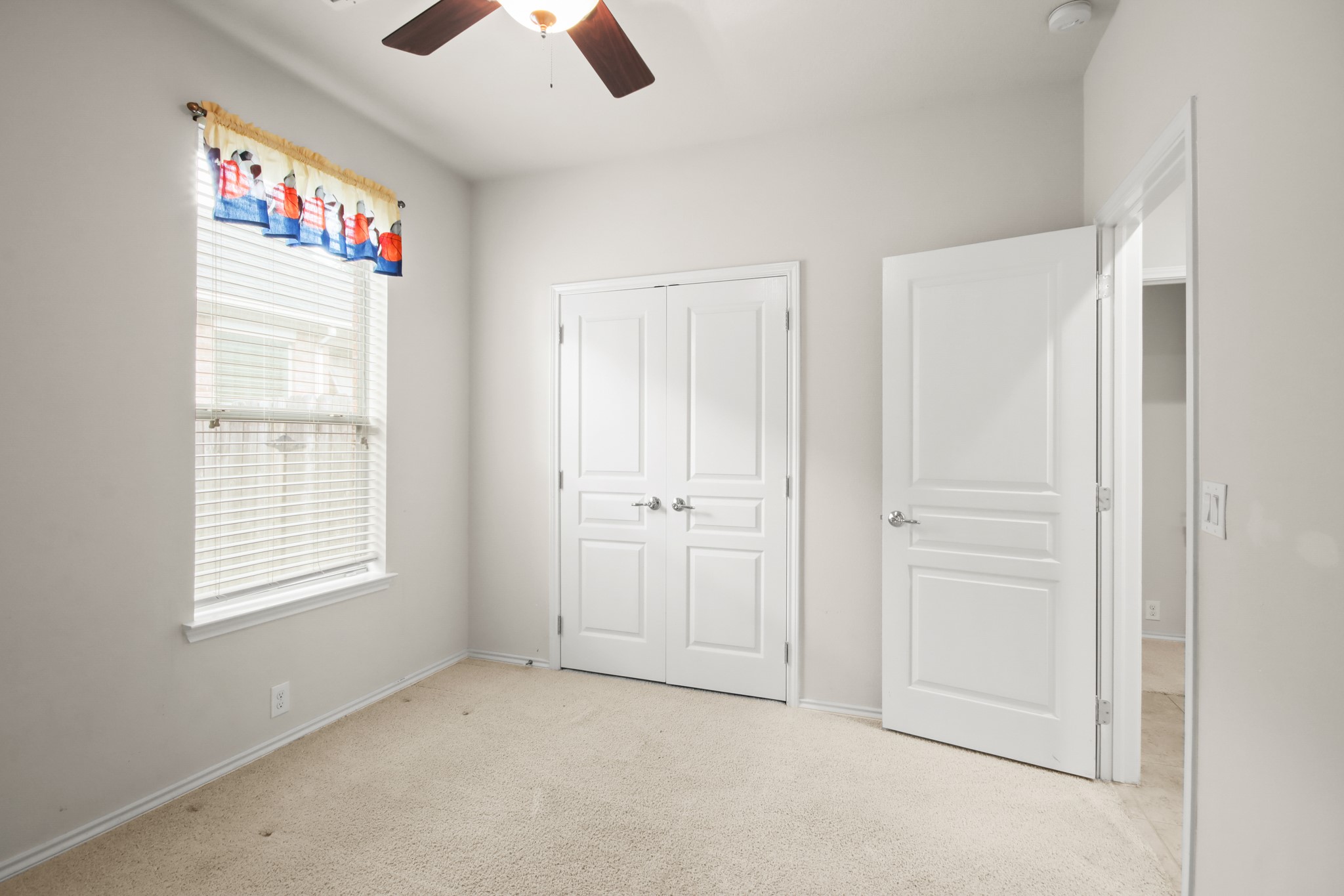 16918 Cherokee Lake Lane Houston, TX 77044 - Photo 20 of 35 an empty room with chandelier fan and windows