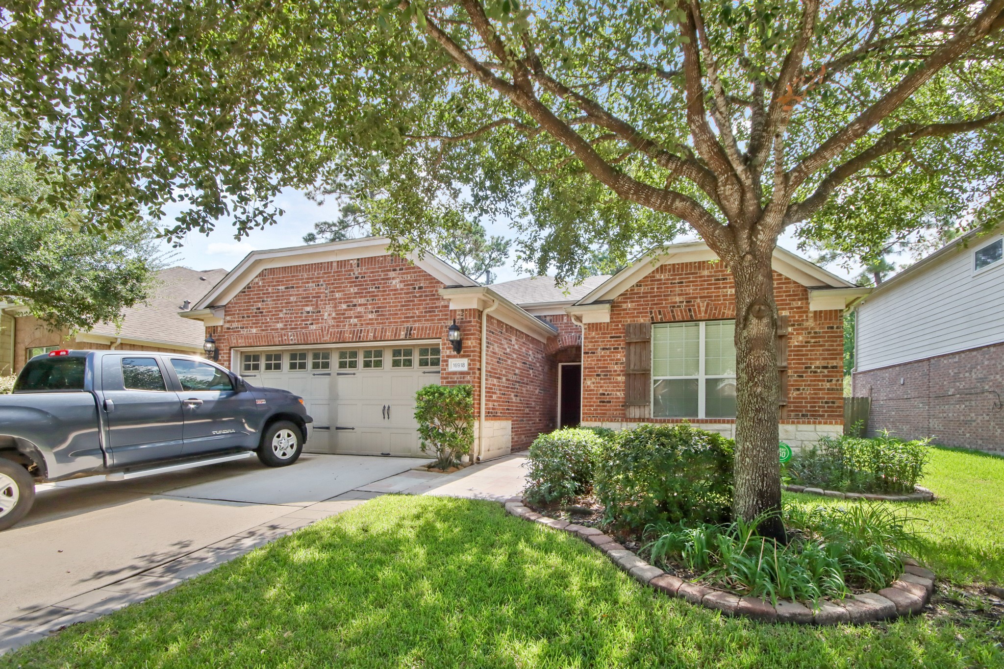 16918 Cherokee Lake Lane Houston, TX 77044 - Photo 32 of 35 front view of a house with a garden