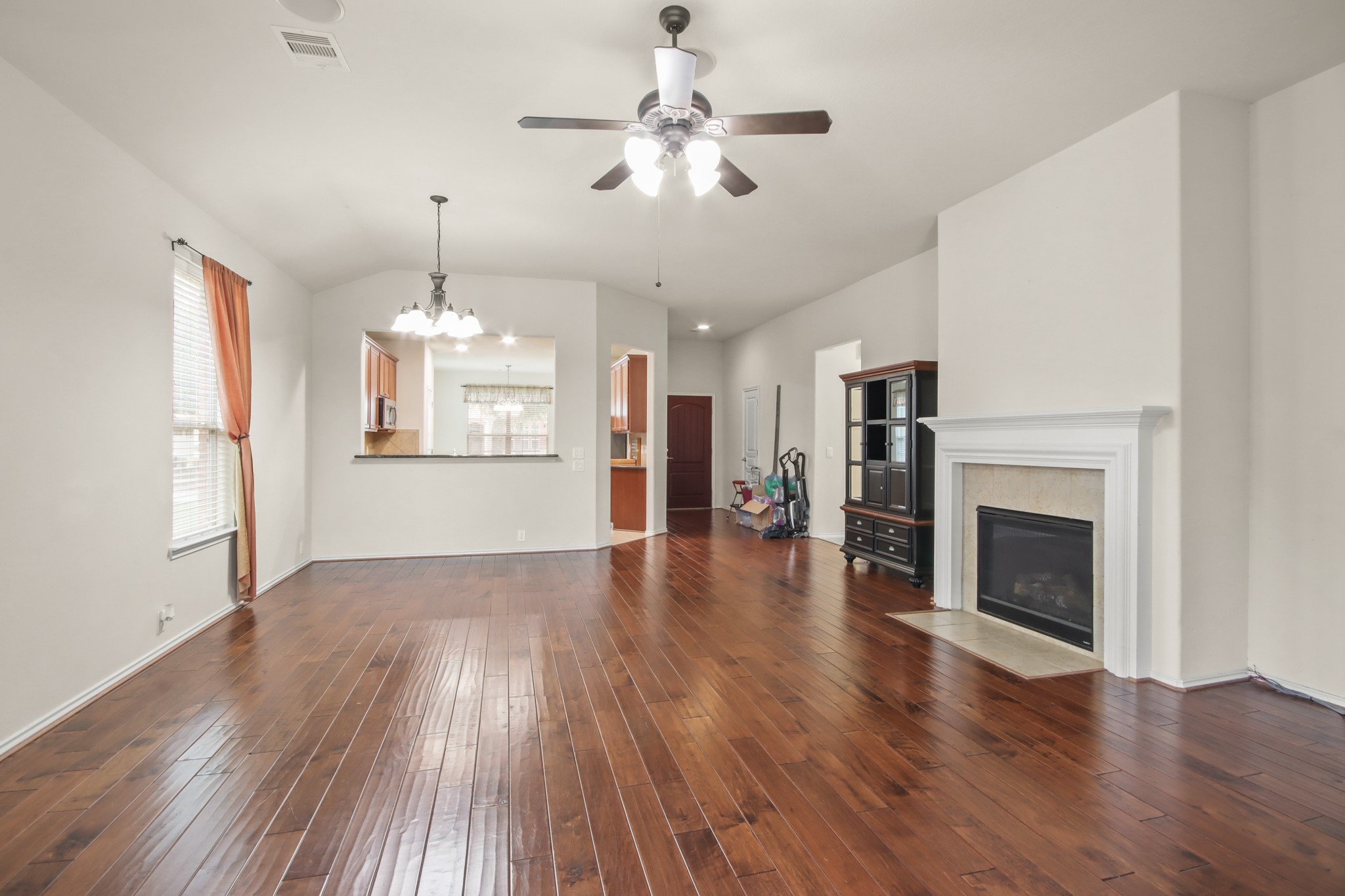 16918 Cherokee Lake Lane Houston, TX 77044 - Photo 4 of 35 a view of an empty room with wooden floor fireplace and a window