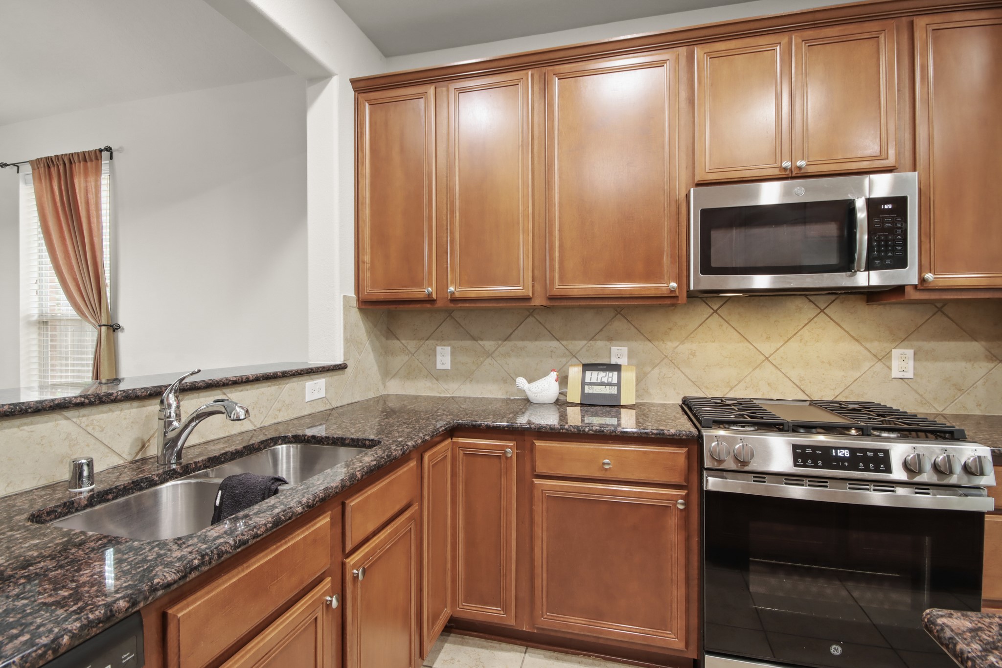 16918 Cherokee Lake Lane Houston, TX 77044 - Photo 5 of 35 a kitchen with granite countertop cabinets stainless steel appliances and a sink