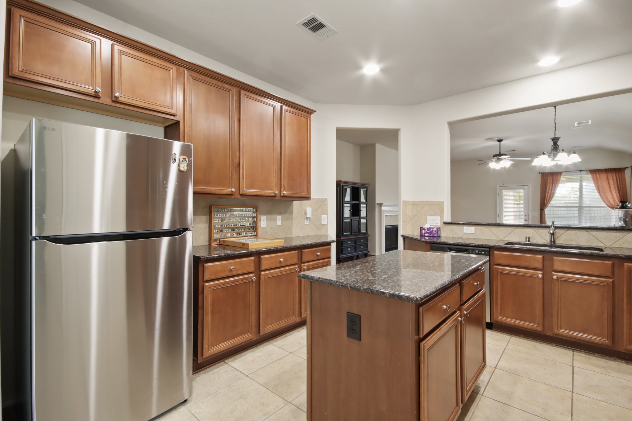 16918 Cherokee Lake Lane Houston, TX 77044 - Photo 6 of 35 a kitchen with stainless steel appliances granite countertop a refrigerator a sink a stove a kitchen island and chairs