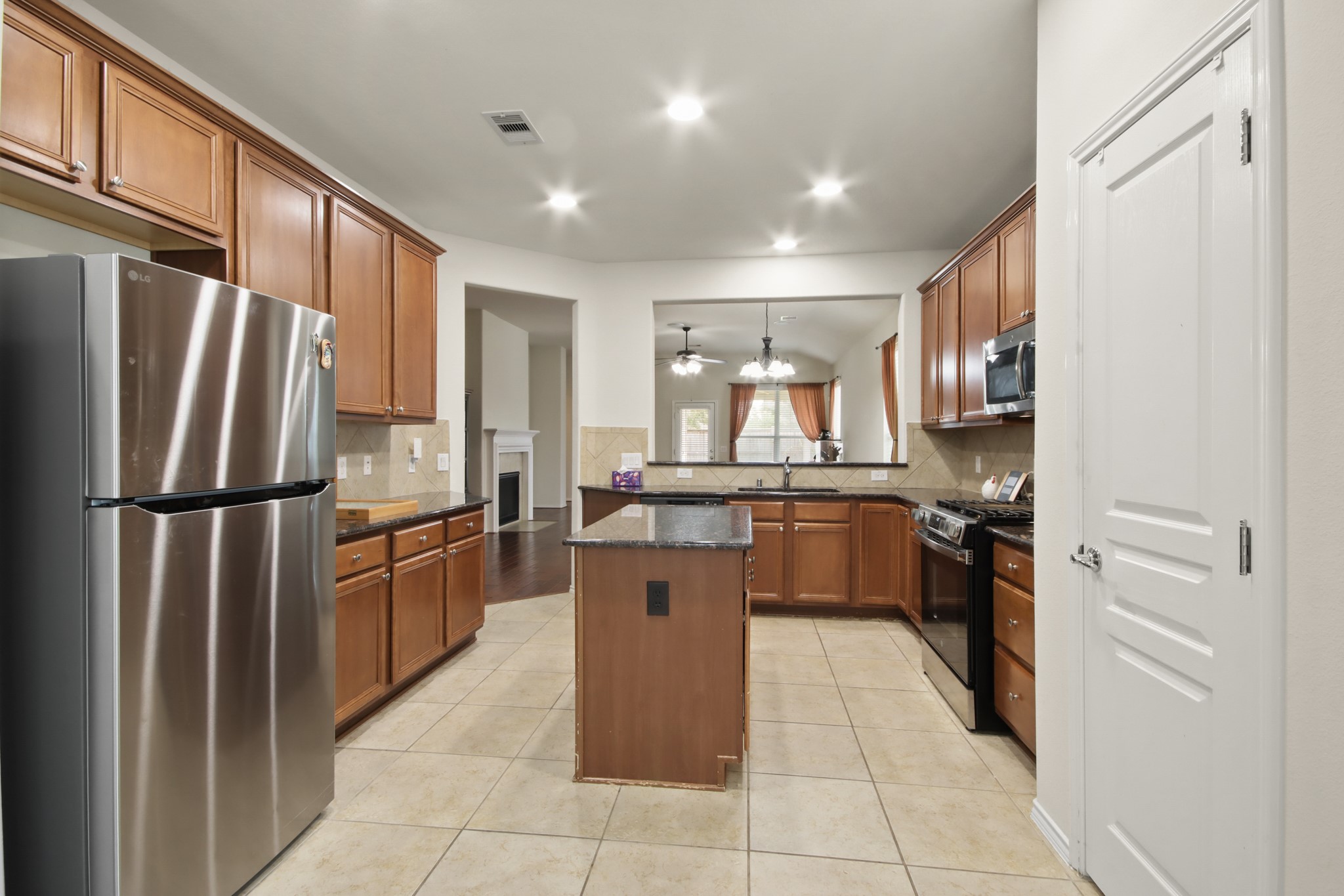 16918 Cherokee Lake Lane Houston, TX 77044 - Photo 8 of 35 a kitchen with a refrigerator and a sink