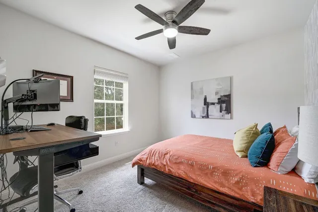 a bedroom with a bed and a table