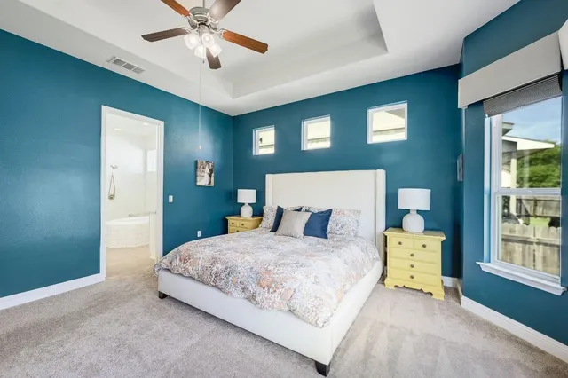 a bedroom with a bed and a chandelier