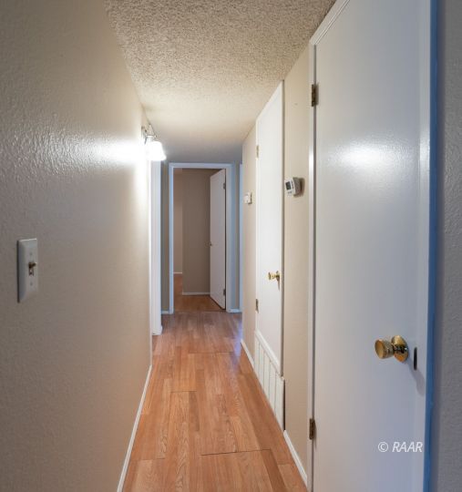 324 West Ward Avenue Ridgecrest, CA 93555 - Photo 7 of 32 a view of a hallway with wooden floor