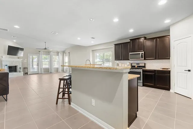 a kitchen with stainless steel appliances granite countertop a refrigerator sink and cabinets