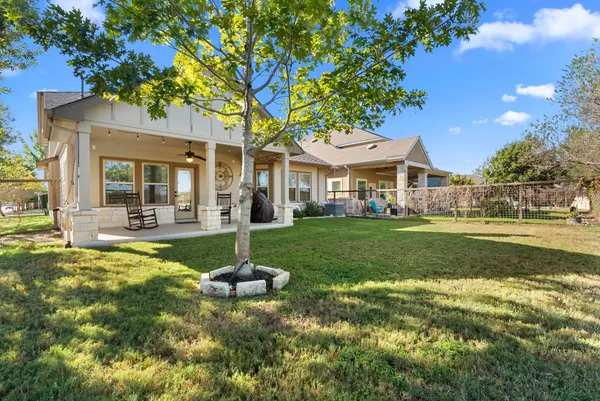 a view of house that has a yard