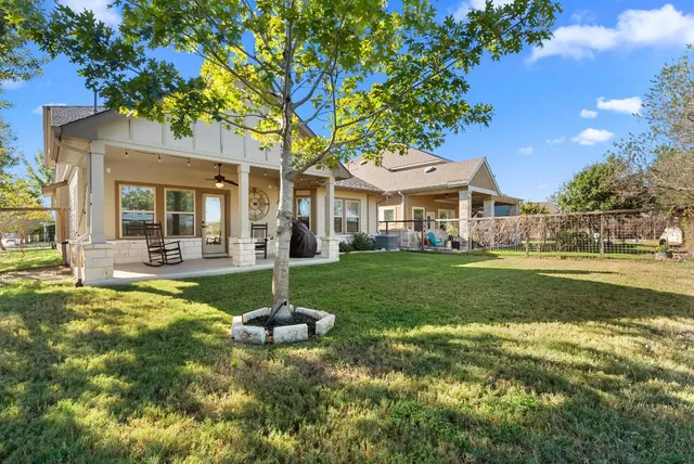 a view of house that has a yard