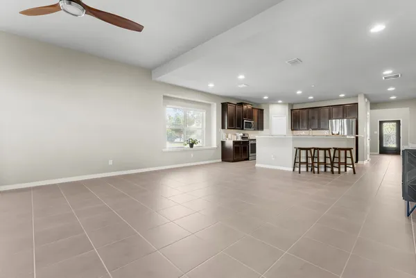 a view of open kitchen with a sink and a large window