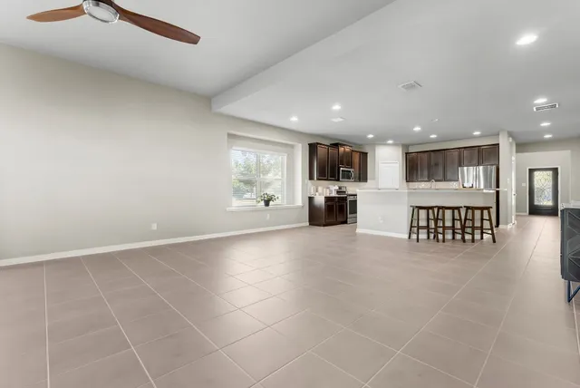 a view of open kitchen with a sink and a large window
